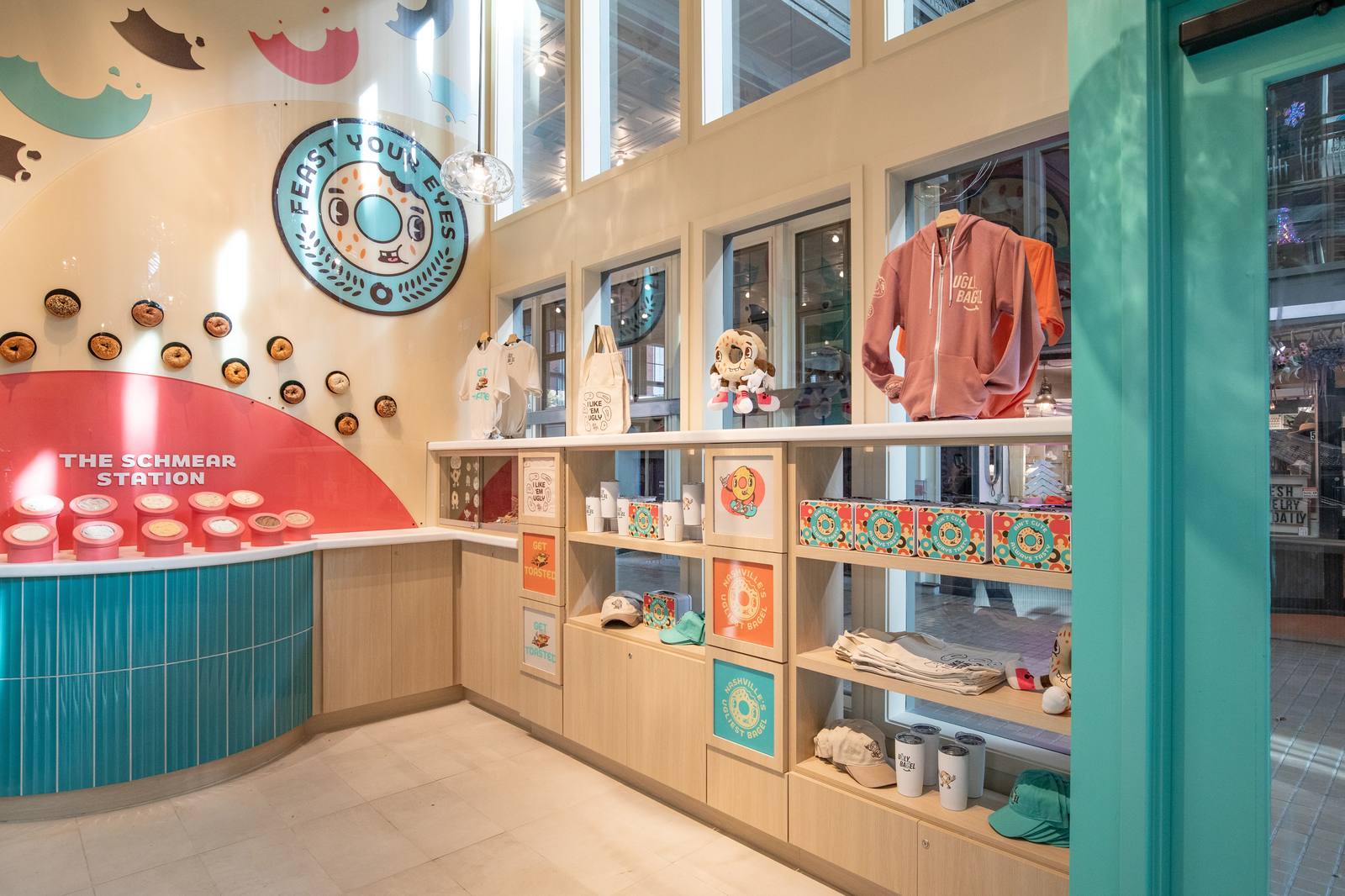 Ugly Bagel retail counter with merchandise shelves